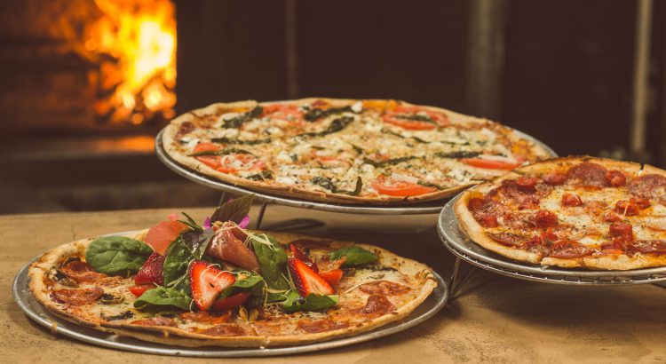 shallow focus photography of several pizzas